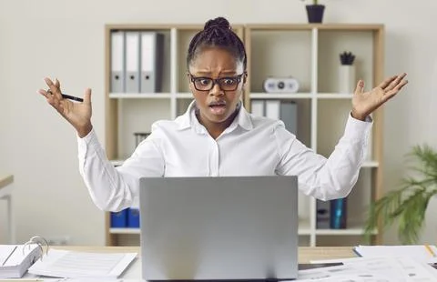 Woman having problem due to error or mistake on her laptop computer at work in Stock Photos