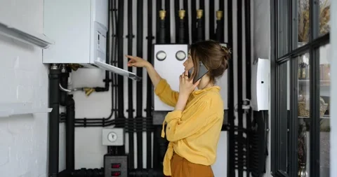 Woman having a problem with heating system at home 動画素材 154944103