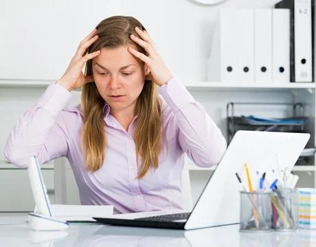 Woman having problem in office Stock Photos