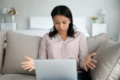 Woman having problems with computer looks at screen feels annoyed Stock Photos