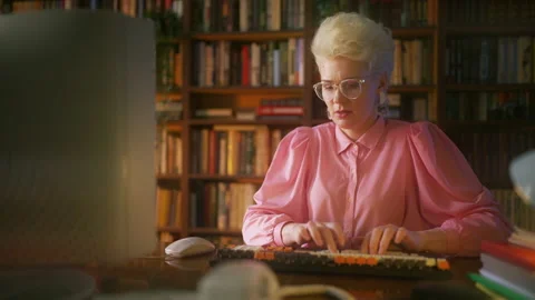 Woman having problems with computer at work, old technology, 80s office Stock Footage 213985370