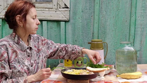 Woman Having Rustic Breakfast at Table Outside Countryside House Stock Footage 337061198