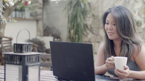Woman having video call while sitting at table in outdoor cafe Stock Footage 166407450
