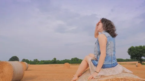 Woman on haystack looking away. Stock Footage 101015999