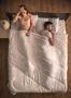 The woman with headache sit on the bed near the man. view from above Photo