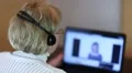 Woman with headphones and notebook speaks with customer HD Footage