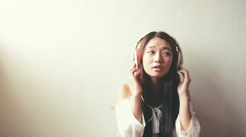 Woman with headphones listen to the music Stock Footage