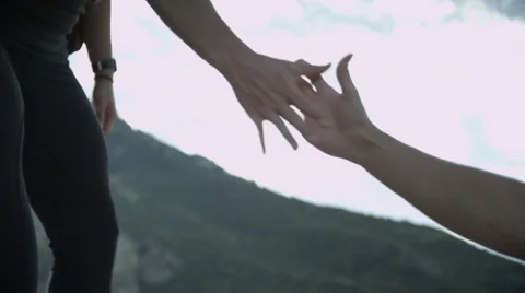 Woman helping another person up the path, teamwork Stock Footage 59835652