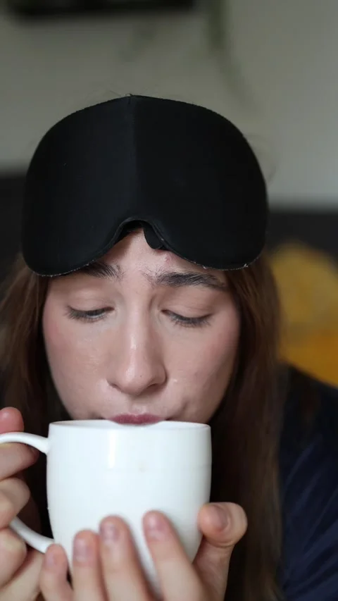 Woman hesitates before drinking coffee while trying to quit caffeine Stock Footage 340087461