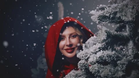 Woman hiding behind tree, looking around in dark night forest winter nature Stock Footage 306970659