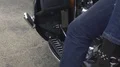 Woman in high heels sitting behind male biker on motorcycle, legs close up HD Footage