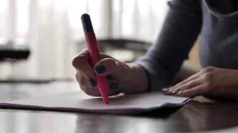 woman highlights text in a document with a highlighter marker. Stock Footage 230919602