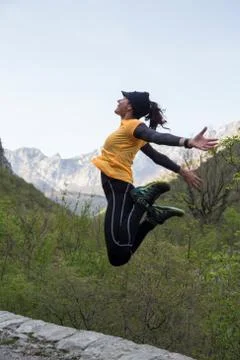 A woman hiker jumping up to the sky. Stock Photos