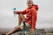 Woman Hiker Relaxing After The Trek Stock Photos
