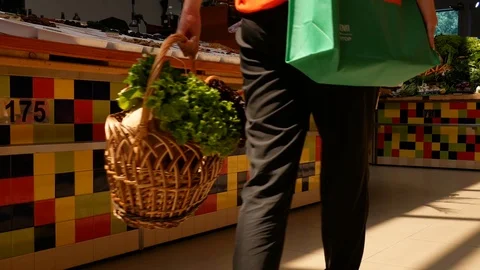 Woman hold basket with lettuce leaves at the market Stock Footage