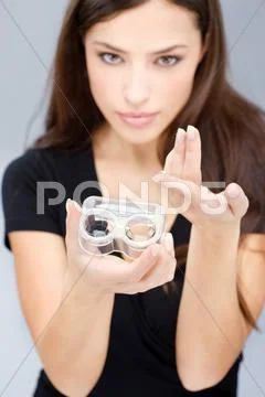 Woman hold contact lenses cases Stock Photos