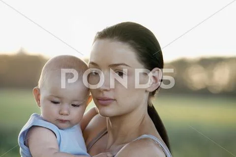Woman holding baby in nature close-up Stock Photos
