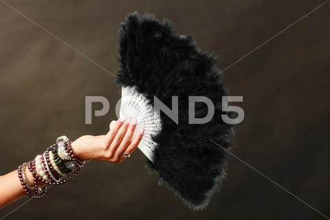 Woman Holding Black Feather Fan In Hand