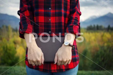 Woman holding a book in the park Stock Photos