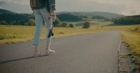 Woman Holding Camera While Walking On Road Video stock 252016923