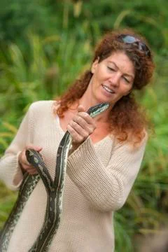 Woman holding a carpet python Photos