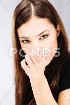 Woman holding contact lens on finger Stock Photos