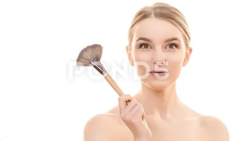 The woman holding a cosmetic brush on the white background Stock Photos