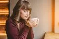 The woman holding a cup in the restaurant Photo
