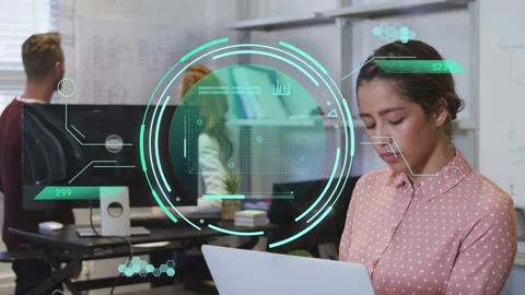Woman holding document using laptop in office, teal HUD appearing guiding data Stock Footage 334744285