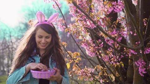 Woman holding Easter basket full of Easter eggs Stock Footage 105437286