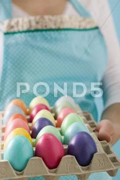 Woman Holding Egg Tray Full Of Coloured Easter Eggs