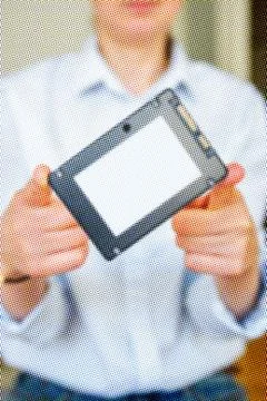 Woman holding fast SSD Solid State Drive Stock Photos