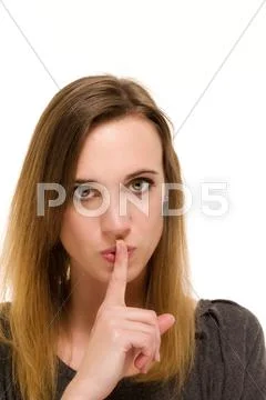 Woman holding a finger to her mouth to shh Stock Photos