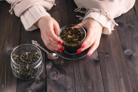 Woman holding hot cup of black tea Stock Photos