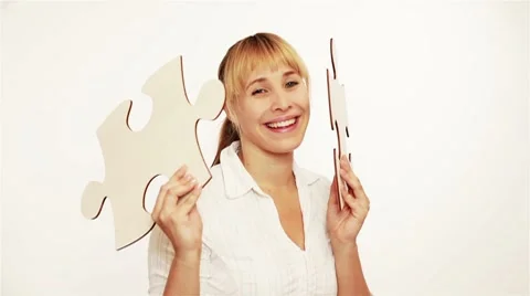 Woman holding jigsaw pieces Stock Footage