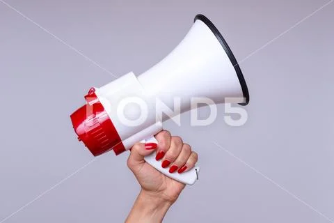 Woman holding up a loud hailer or megaphone Stock Photos
