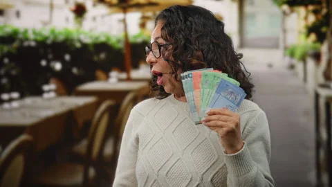 Woman holding malaysian ringgit banknotes with surprised expression at an o.. Stock Footage 313474792