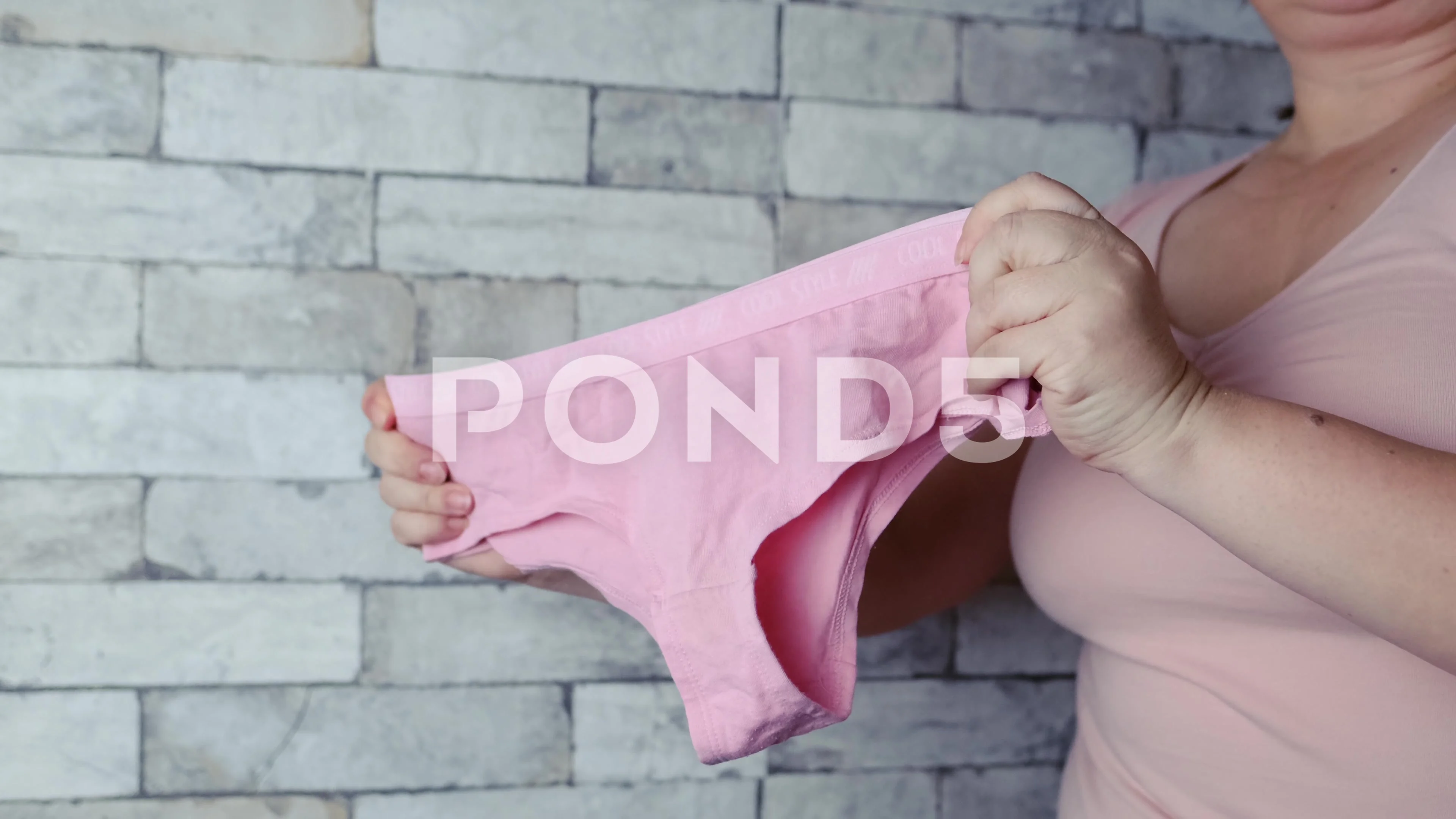 woman holding pink female panties in han, Stock Video