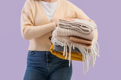 Woman holding stack of clean folded laundry, freshly washed clothes, home cho Stock Photos