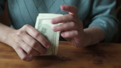Woman holding stack of dollar bills in her hands. Stock Footage 317173732