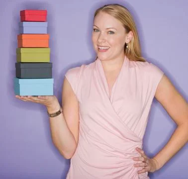 Woman holding stack of gift boxes Stock Photos