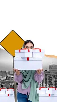 A woman is holding a stack of white boxes and a yellow sign Stock Photos