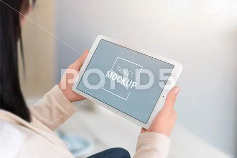 Woman holding tablen in horizontal position. Smart object display for mockup, ap PSD Template