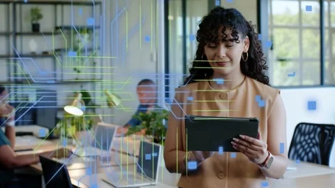 Woman holding tablet tapping in office, causing HUD code overlays to escalate Stock Footage 333720006