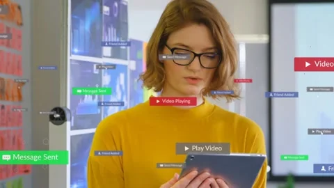 Woman holding tablet in tech office, looking down and causing UI badges to Stock Footage 335255280