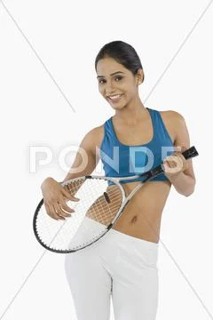 Woman holding a tennis racket and smiling Stock Photos