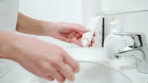 Woman holding toothpaste and preparing for brushing teeth. Stock Footage 155145146