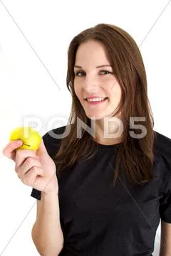 Woman holding a yellow apple and smiling Stock Photos