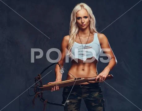 A woman holds crossbow. Stock Photos
