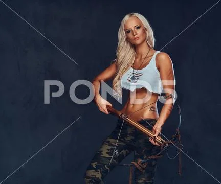 A woman holds crossbow. Stock Photos